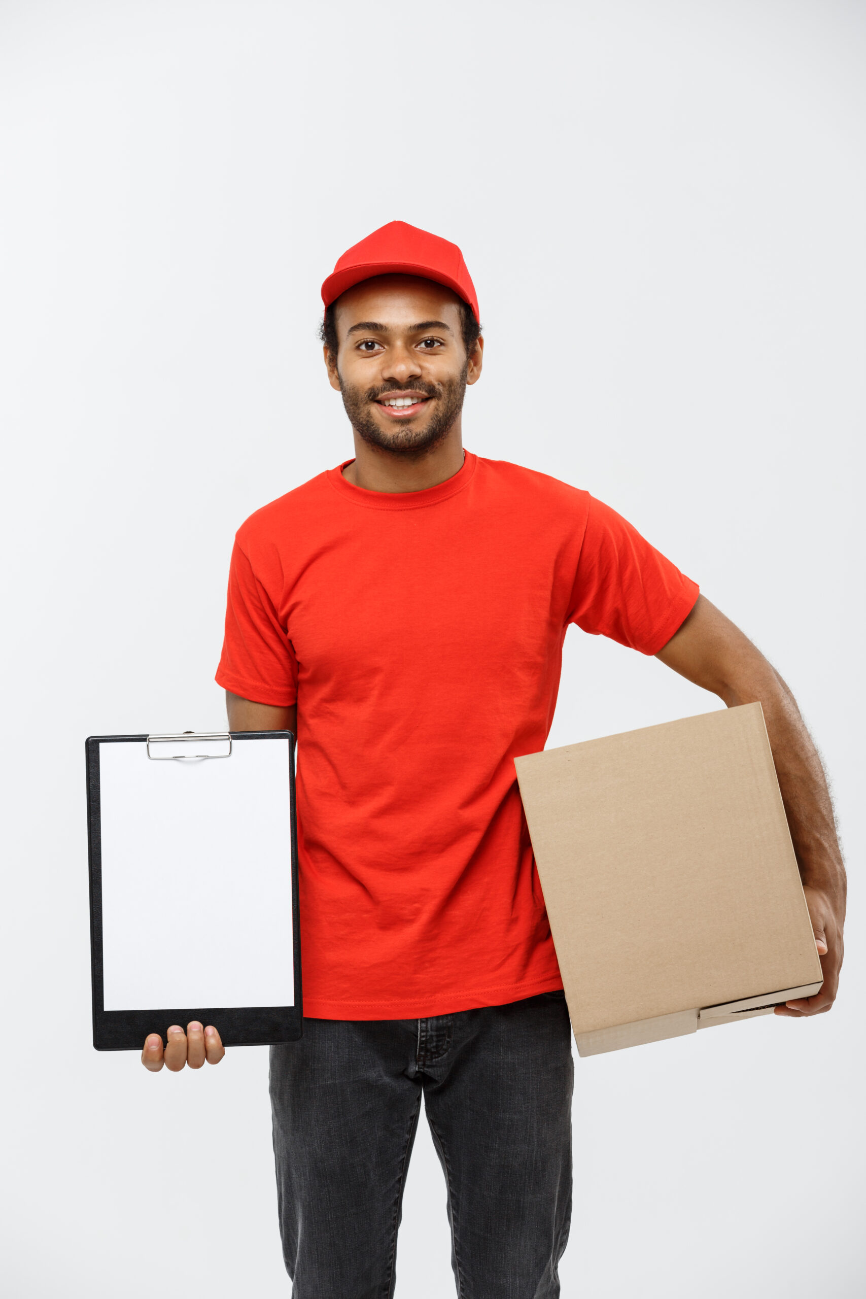 Delivery Concept - Portrait of Handsome African American delivery man or courier showing a confirmation document form to sign. Isolated on Grey studio Background. Copy Space. Delivery Concept - Portrait of Handsome African American delivery man or courier showing a confirmation document form to sign. Isolated on Grey studio Background. Copy Space.